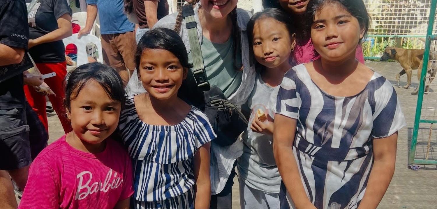 A school hall in the Philippines filled with young people listening during an outreach